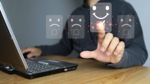 Customer service evaluation concept. Businessman pressing face smile emoticon show on virtual screen. Survey, poll or questionnaire for user experience or customer satisfaction